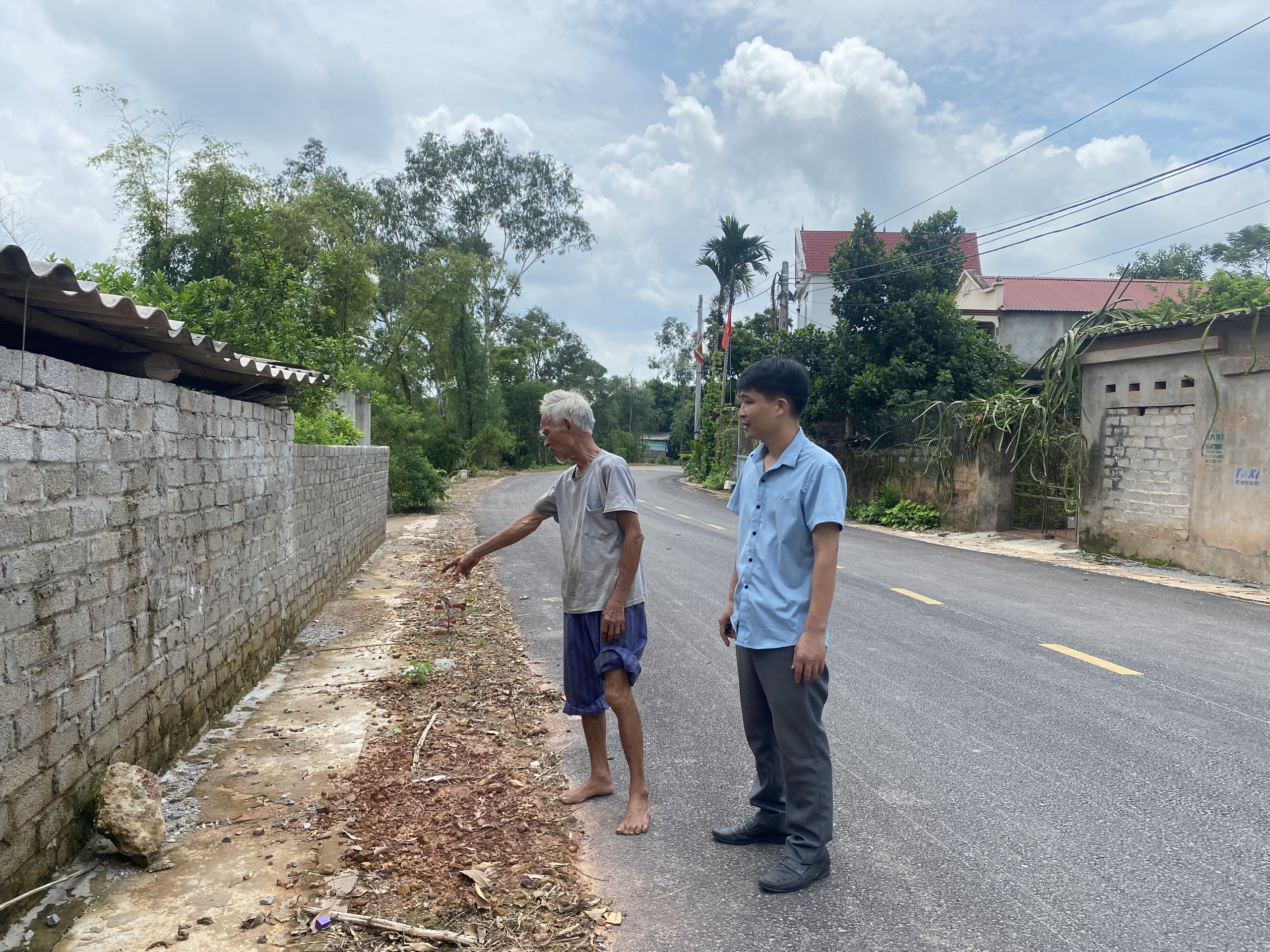 Ông Hồng giới thiệu khu vực hiến đất để mở rộng đường liên thôn xã Nghĩa Hòa