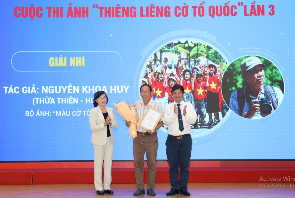 Bà Phạm Phương Thảo - nguyên Phó Bí thư Thành ủy TP HCM, nguyên Chủ tịch HĐND TP HCM - và ông Trần Trọng Dũng, Phó Chủ tịch Hội Nhà báo Việt Nam, trao giải Nhì cho tác giả Nguyễn Khoa Huy. Ảnh: Hoàng Triều